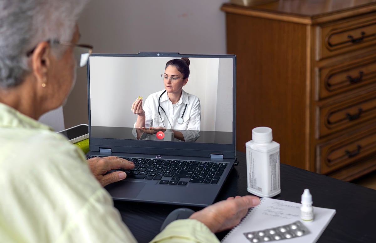 Doctor video consultation with patient on laptop